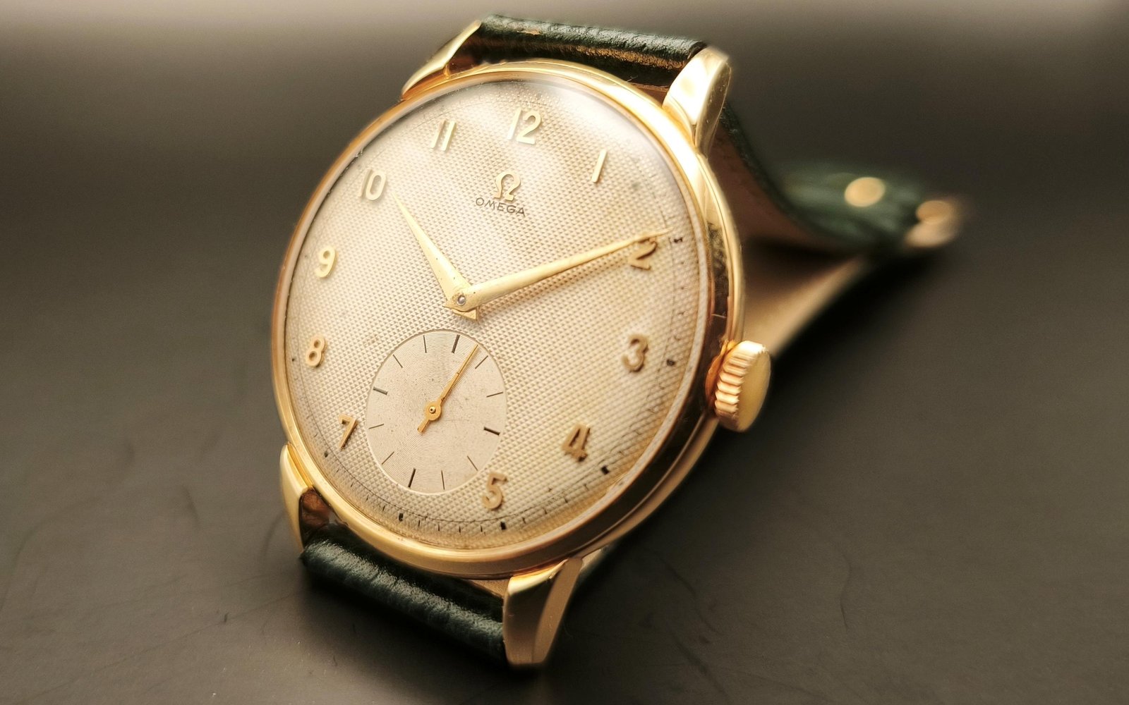 Vintage Omega 18K gold mechanical watch from 1952 showcasing classic watch design with handcrafted movement, aged dial with vintage watch patina, and timeless craftsmanship from private watch collection