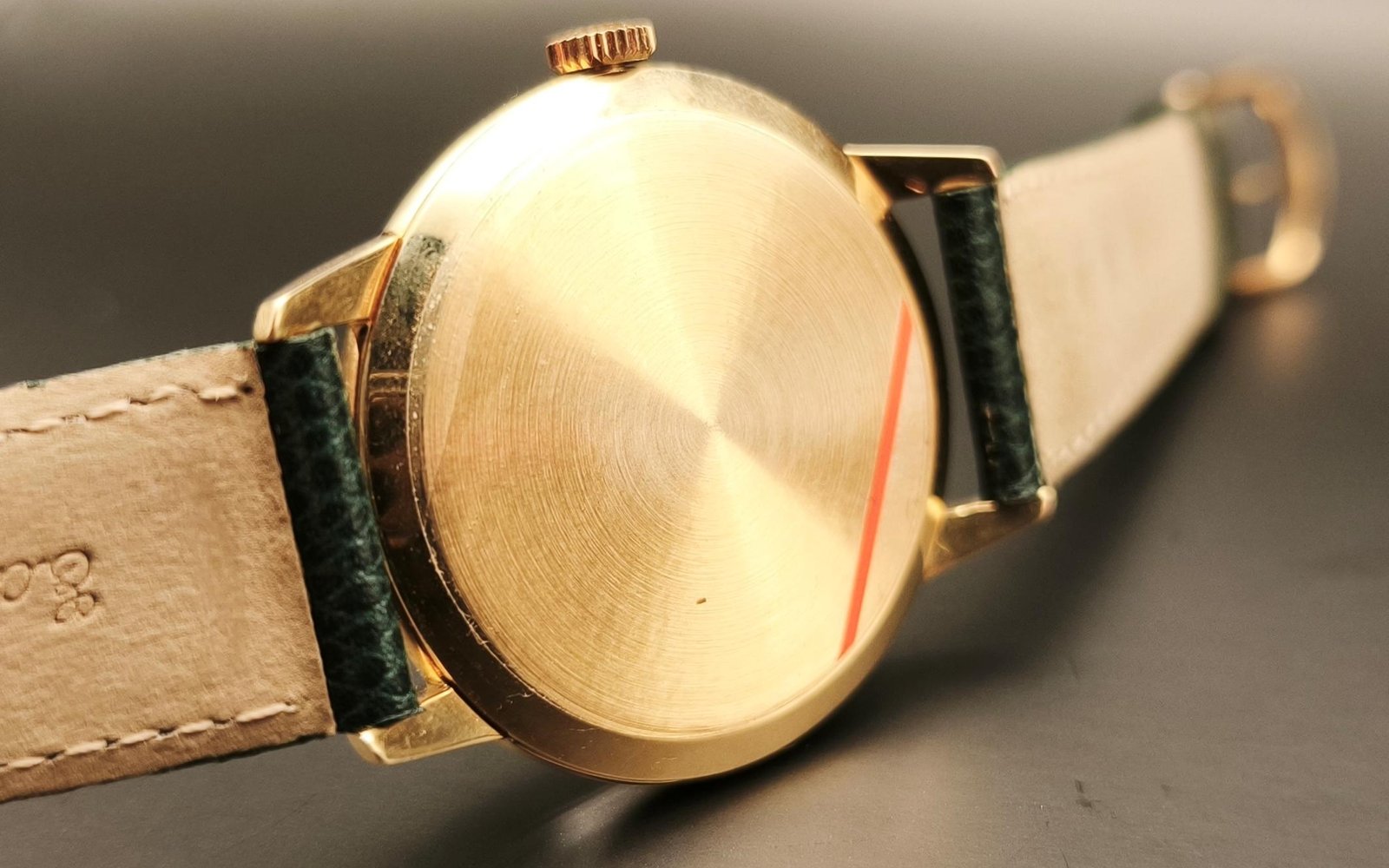 Vintage Omega 18K gold watch case back from 1952 showing hallmarks, reference number 2687, engraved details, gold patina, and vintage watch authentication marks from private watch collection