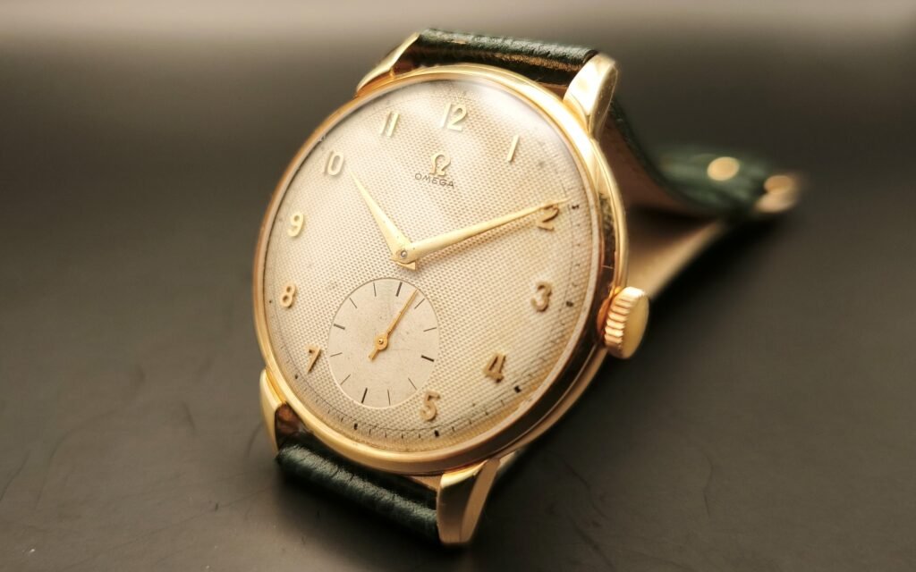 Vintage Omega 18K gold mechanical watch from 1952 showcasing classic watch design with handcrafted movement, aged dial with vintage watch patina, and timeless craftsmanship from private watch collection