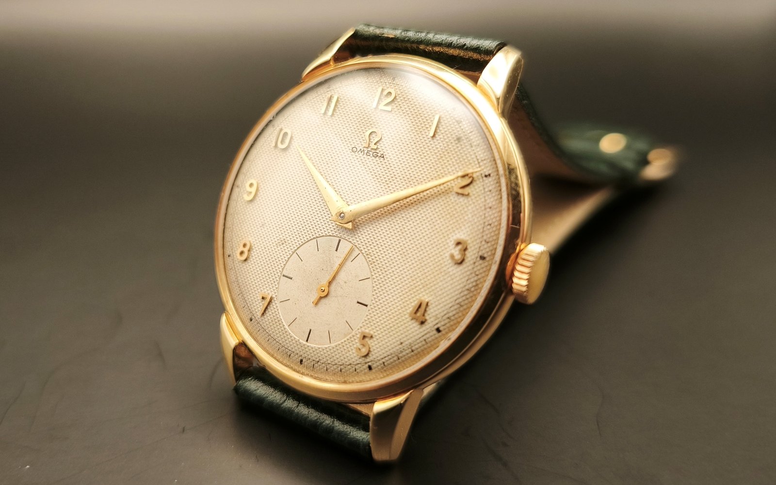Vintage Omega 18K gold mechanical watch from 1952 showcasing classic watch design with handcrafted movement, aged dial with vintage watch patina, and timeless craftsmanship from private watch collection
