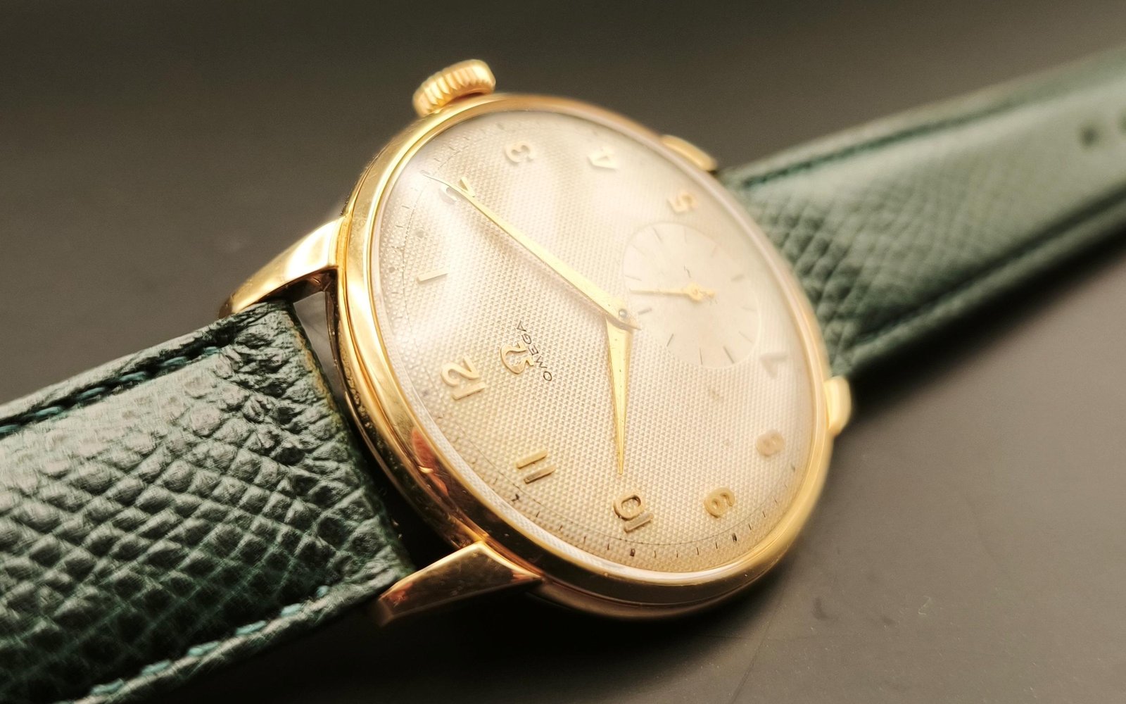 Vintage Omega 18K gold mechanical watch from 1952 showcasing classic watch design with handcrafted movement, aged dial with vintage watch patina, and timeless craftsmanship from private watch collection