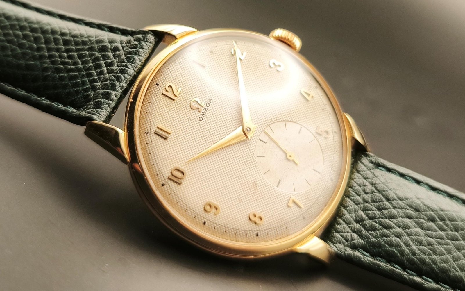 Vintage Omega 18K gold mechanical watch from 1952 showcasing classic watch design with handcrafted movement, aged dial with vintage watch patina, and timeless craftsmanship from private watch collection