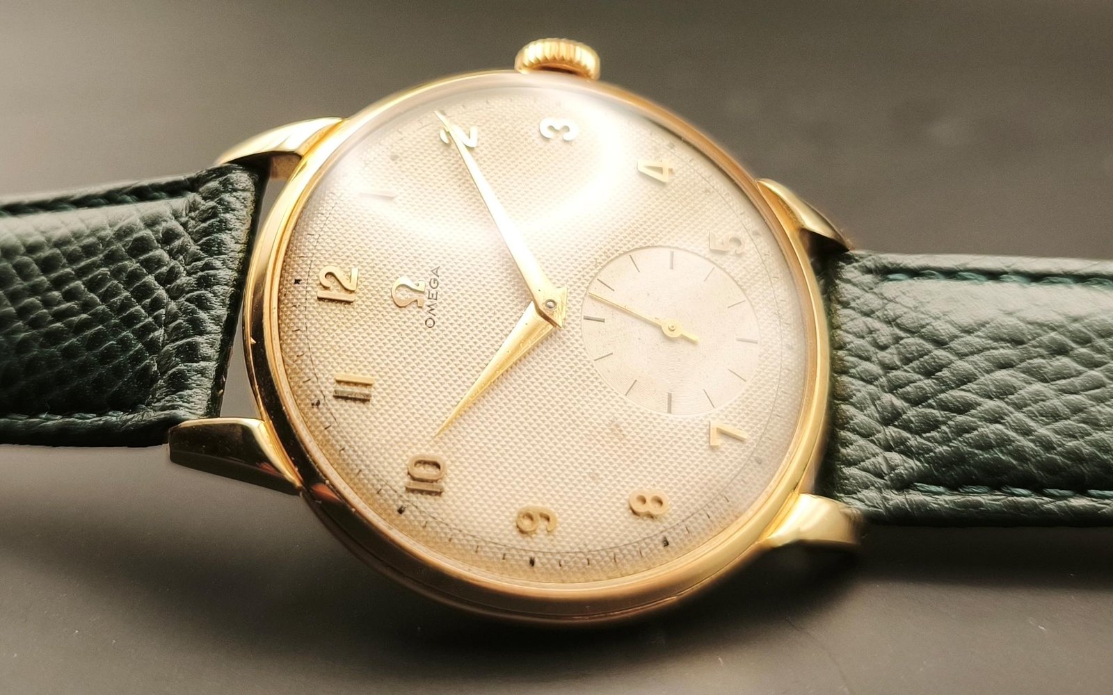 Vintage Omega 18K gold mechanical watch from 1952 showcasing classic watch design with handcrafted movement, aged dial with vintage watch patina, and timeless craftsmanship from private watch collection
