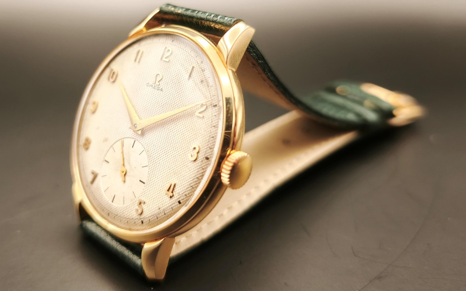 Vintage Omega 18K gold mechanical watch from 1952 showcasing classic watch design with handcrafted movement, aged dial with vintage watch patina, and timeless craftsmanship from private watch collection