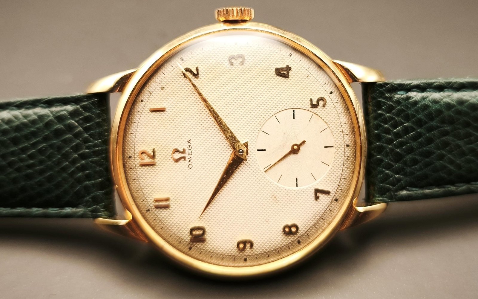 Vintage Omega 18K gold mechanical watch from 1952 showcasing classic watch design with handcrafted movement, aged dial with vintage watch patina, and timeless craftsmanship from private watch collection