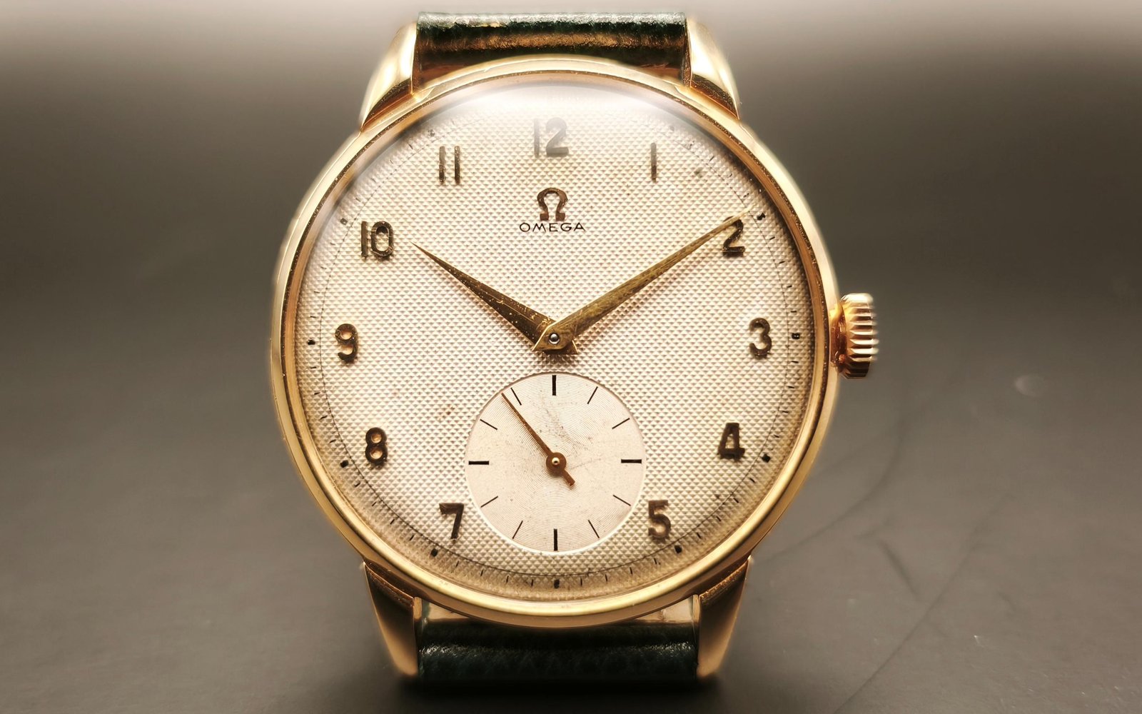Vintage Omega 18K gold mechanical watch from 1952 showcasing classic watch design with handcrafted movement, aged dial with vintage watch patina, and timeless craftsmanship from private watch collection