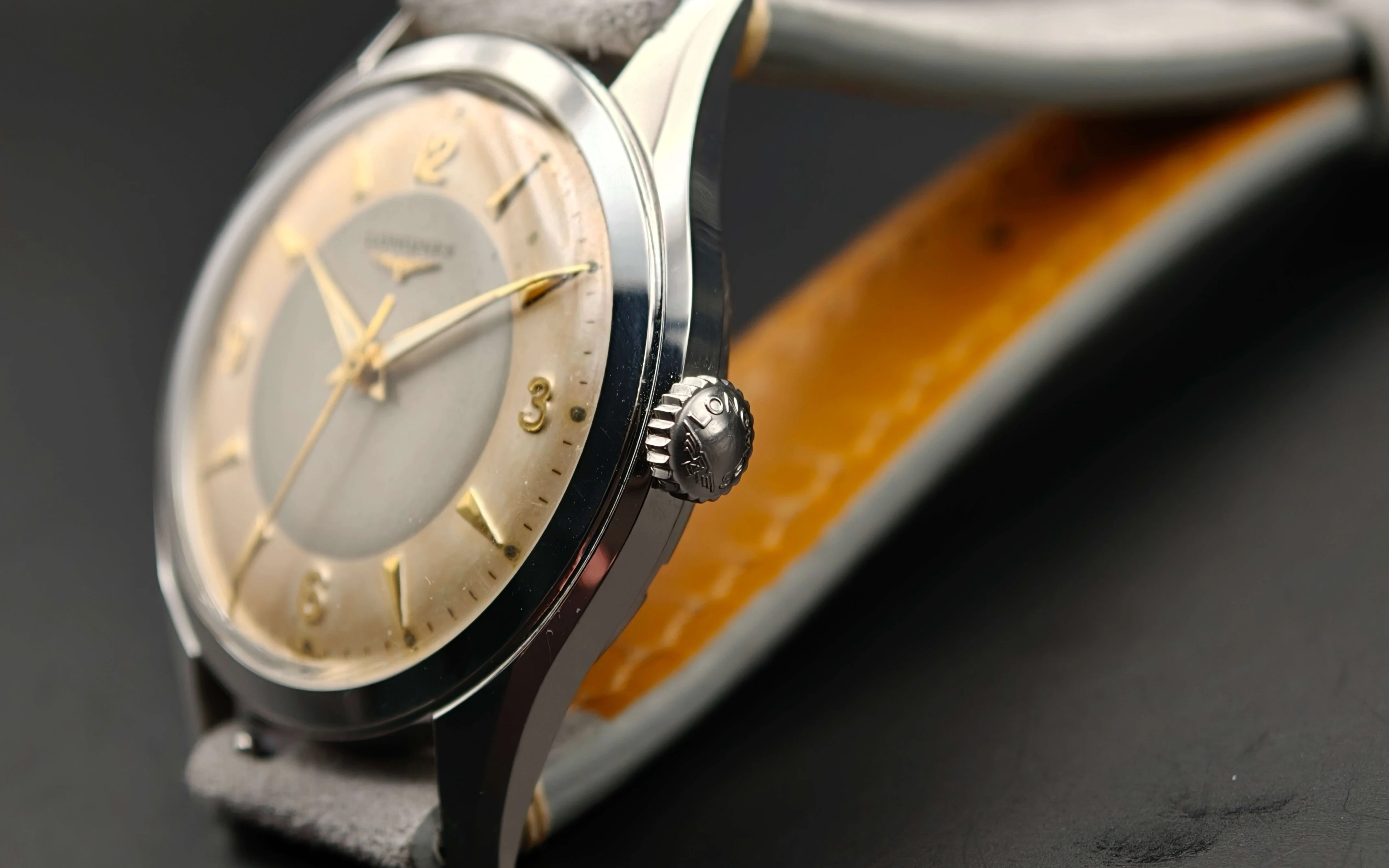 Vintage Longines stainless steel mechanical watch from 1954 showcasing classic watch design with handcrafted movement, aged two-tone dial with warm tropical patina, and timeless craftsmanship from private watch collection.