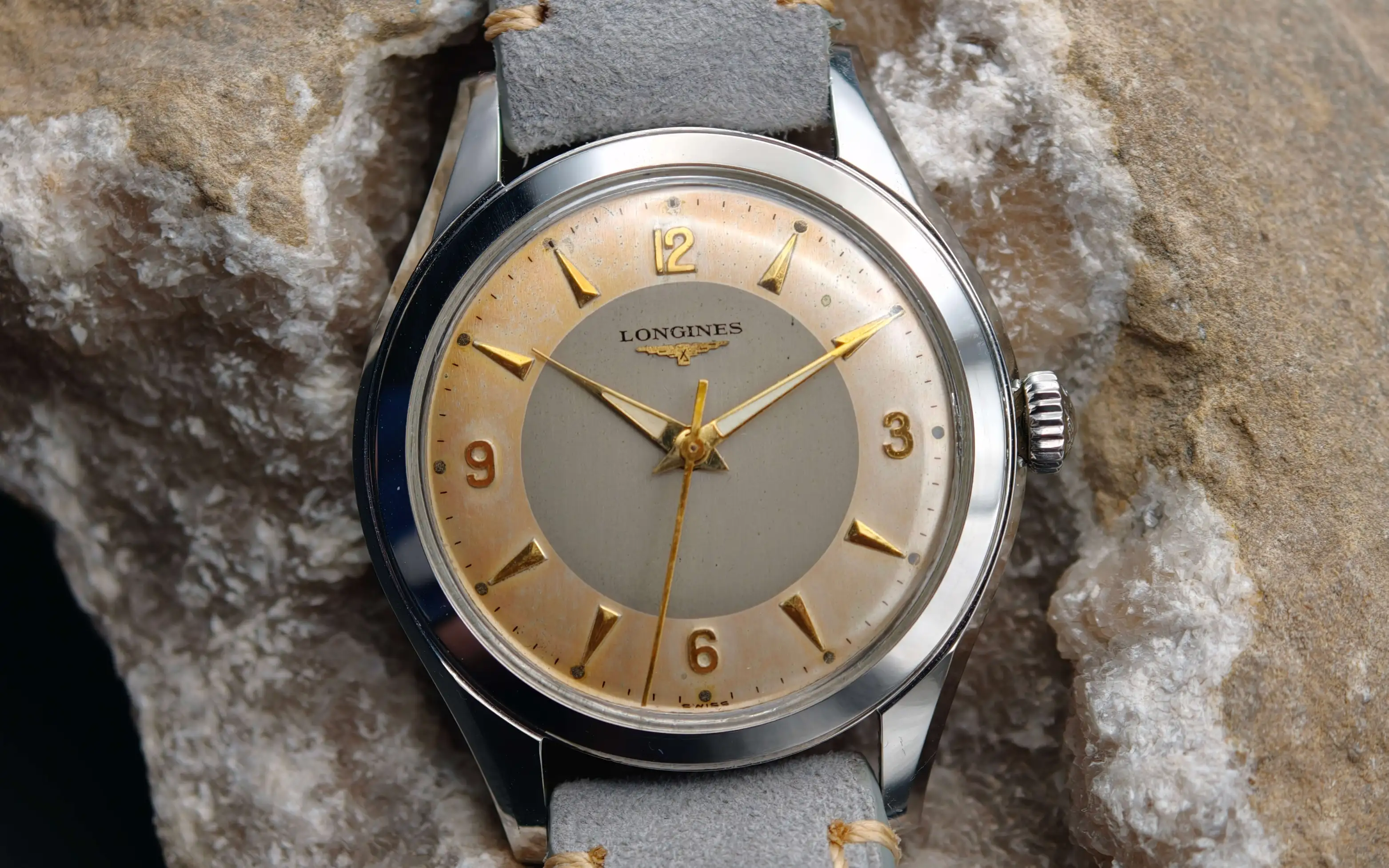 Vintage Longines stainless steel mechanical watch from 1954 showcasing classic watch design with handcrafted movement, aged two-tone dial with warm tropical patina, and timeless craftsmanship from private watch collection.