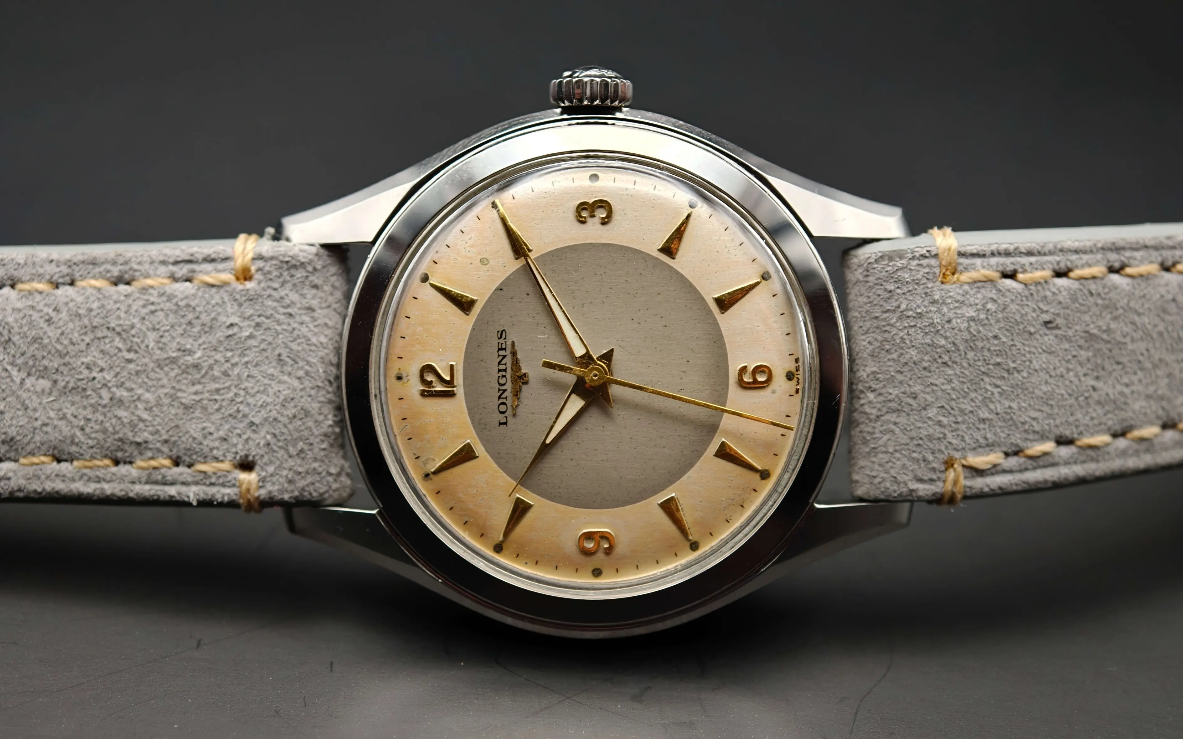 Vintage Longines stainless steel mechanical watch from 1954 showcasing classic watch design with handcrafted movement, aged two-tone dial with warm tropical patina, and timeless craftsmanship from private watch collection.