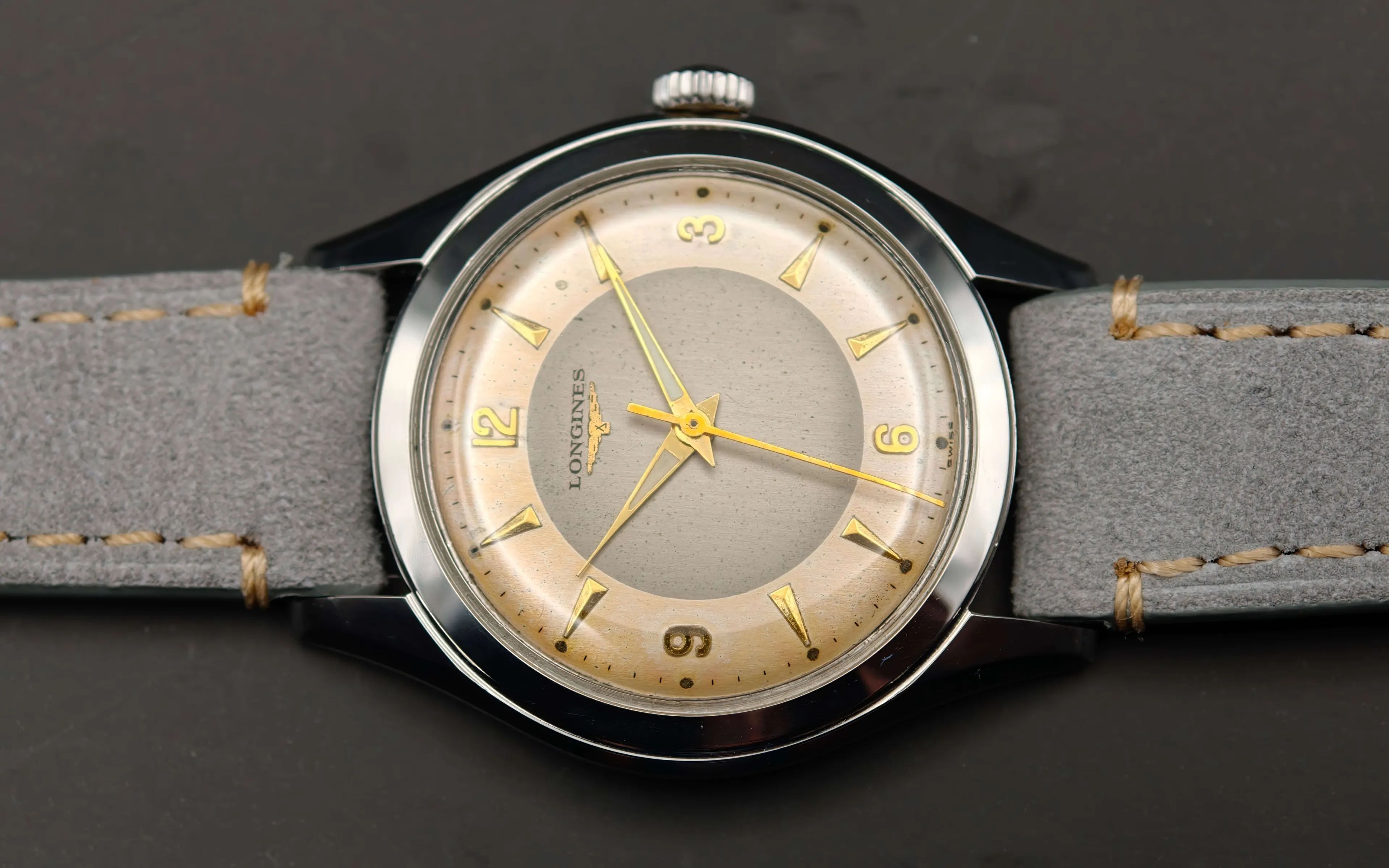 Vintage Longines stainless steel mechanical watch from 1954 showcasing classic watch design with handcrafted movement, aged two-tone dial with warm tropical patina, and timeless craftsmanship from private watch collection.