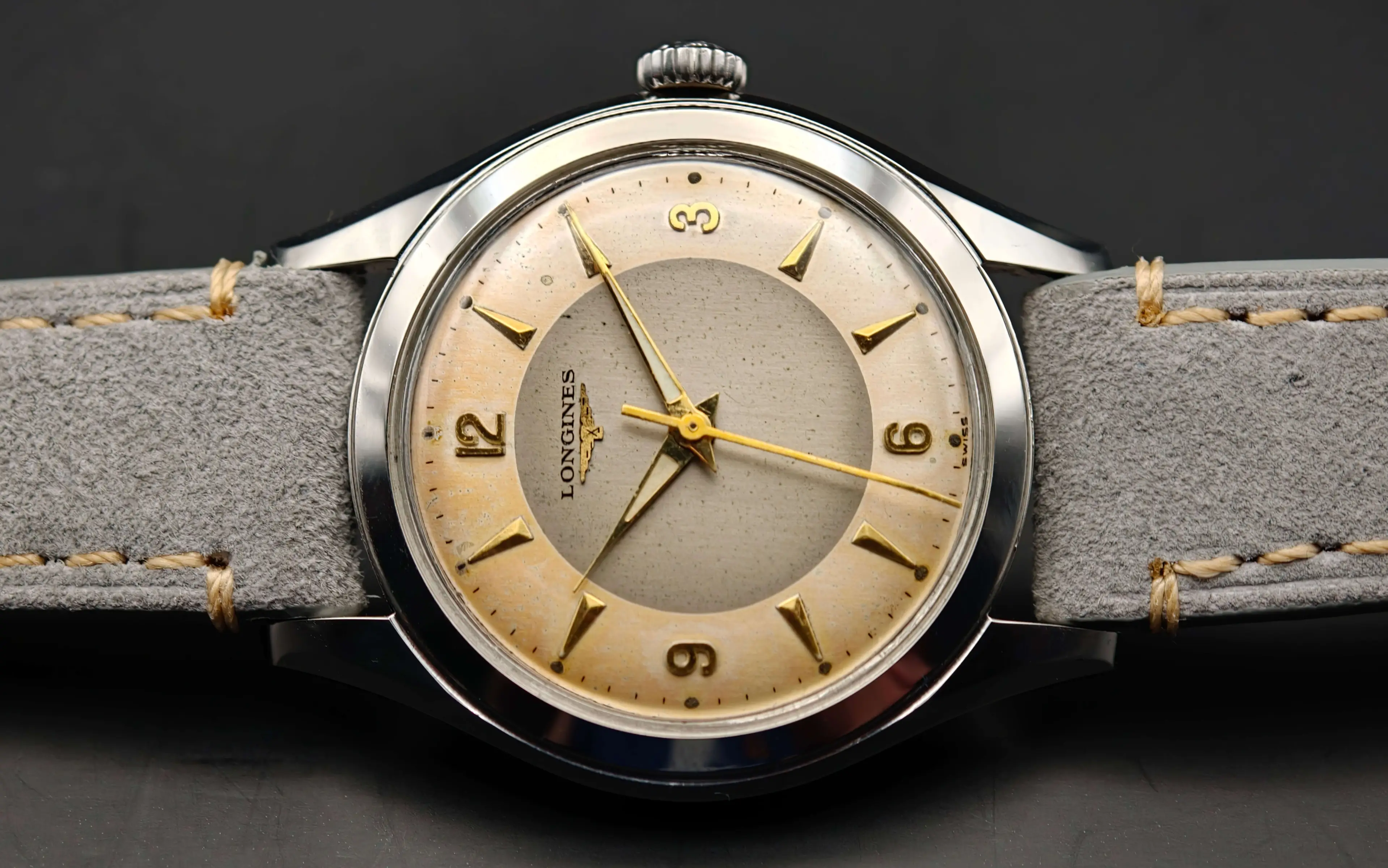 Vintage Longines stainless steel mechanical watch from 1954 showcasing classic watch design with handcrafted movement, aged two-tone dial with warm tropical patina, and timeless craftsmanship from private watch collection.