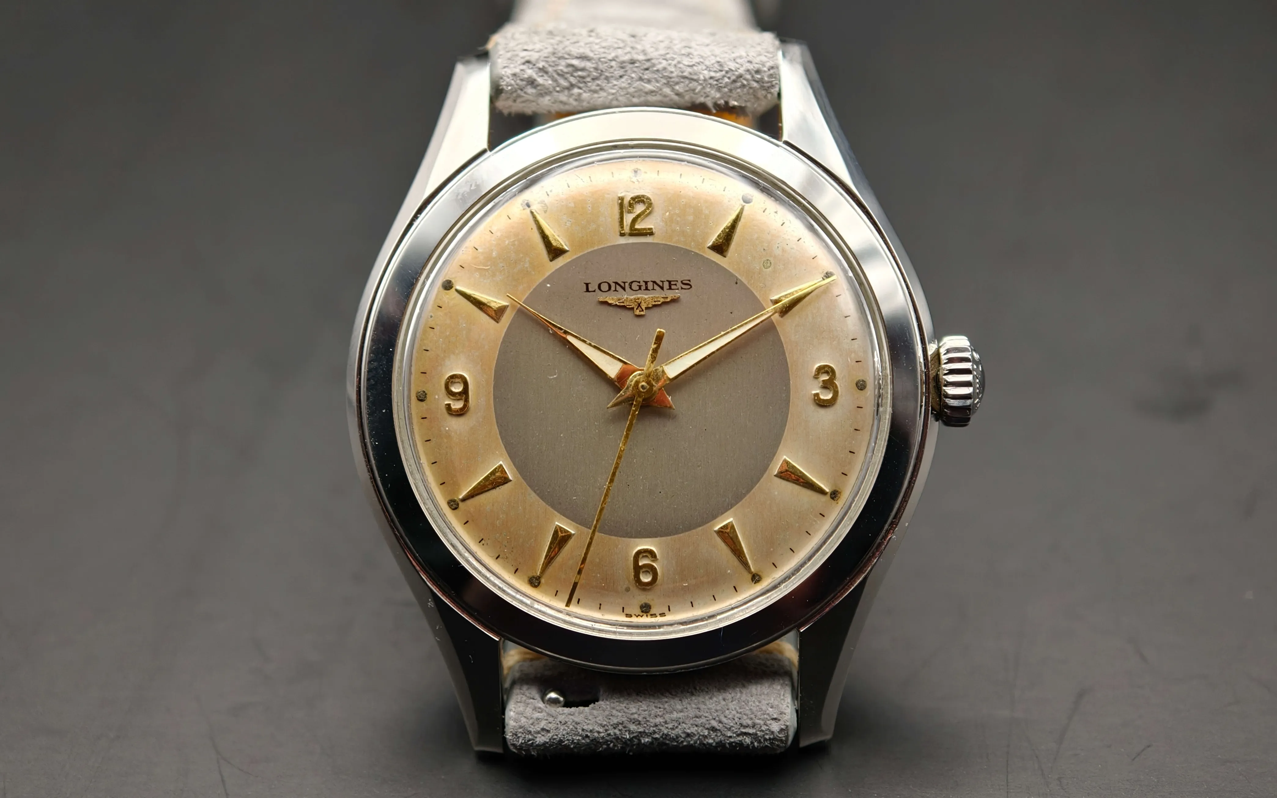 Vintage Longines stainless steel mechanical watch from 1954 showcasing classic watch design with handcrafted movement, aged two-tone dial with warm tropical patina, and timeless craftsmanship from private watch collection.