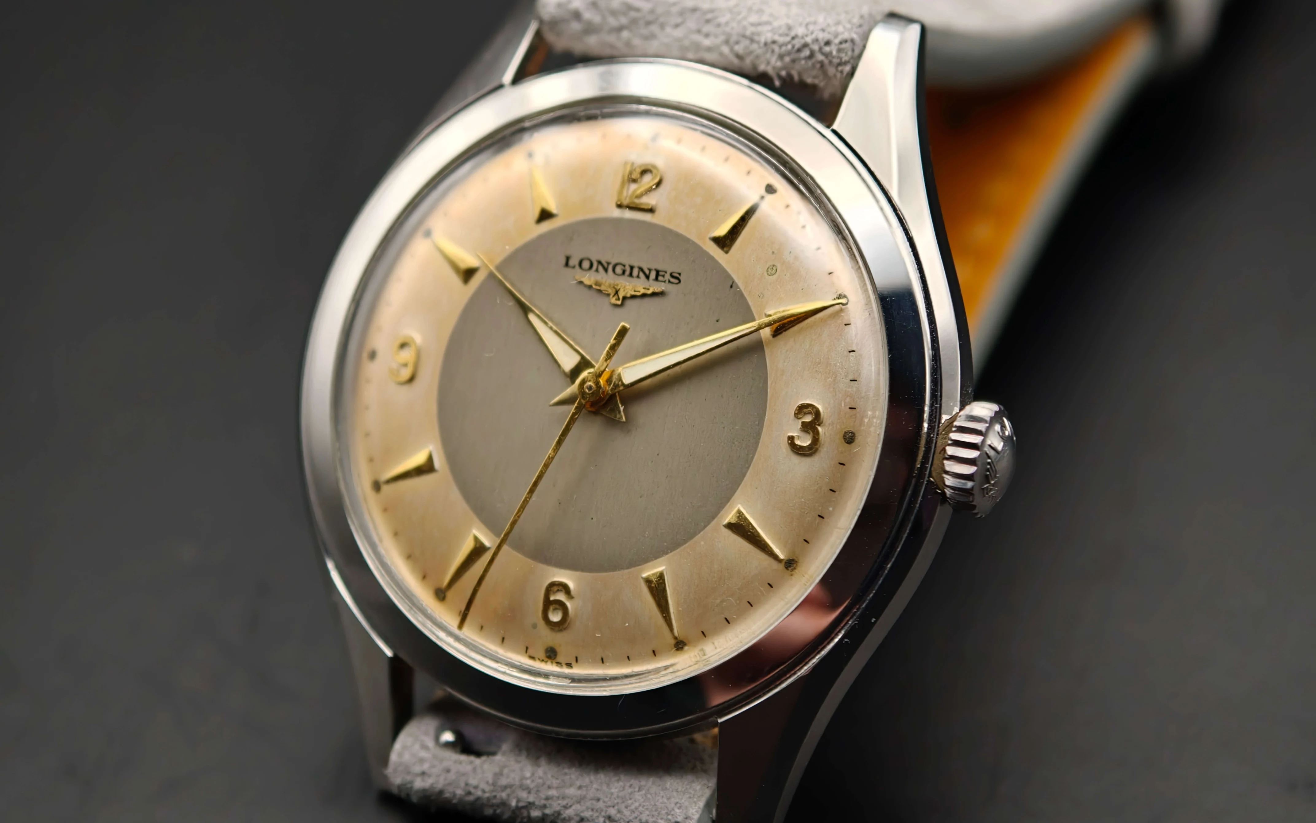 Vintage Longines stainless steel mechanical watch from 1954 showcasing classic watch design with handcrafted movement, aged two-tone dial with warm tropical patina, and timeless craftsmanship from private watch collection.